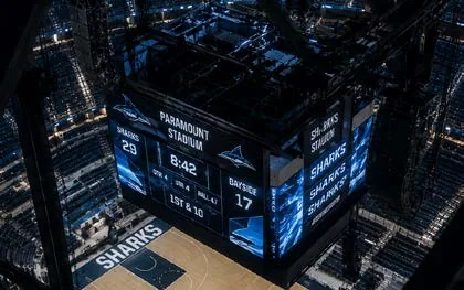 Center-hung arena scoreboard viewed from the rigging